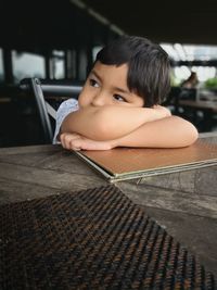 Portrait of boy holding while sitting at home