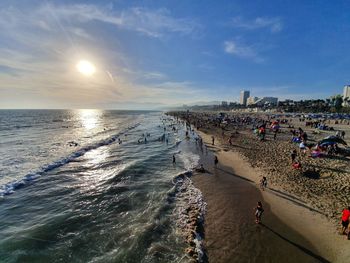 People on beach against sky