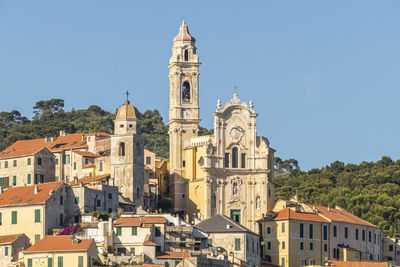 Buildings in city against clear sky