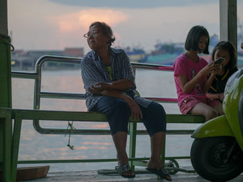 Rear view of two women sitting on seat