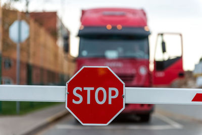 Stop sign on barricade against semi-truck