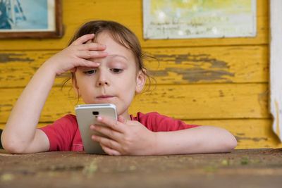 Portrait of boy using mobile phone