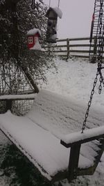 Snow covered railing against sky