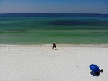 People on beach against sky