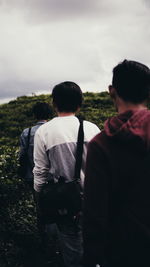 Rear view of people looking at sky