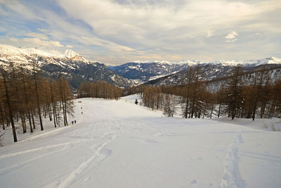 Scenic view of snow covered mountains against sky