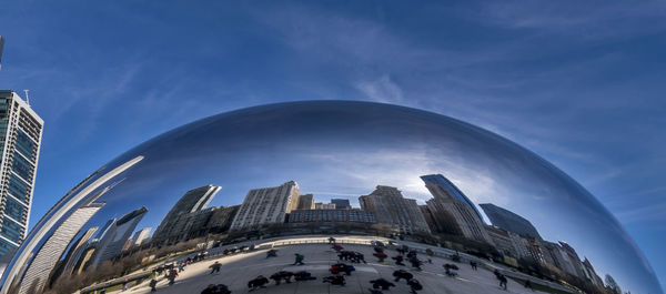Low angle view of modern buildings against blue sky