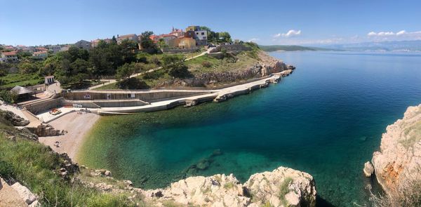 Panoramic shot of sea and buildings against sky