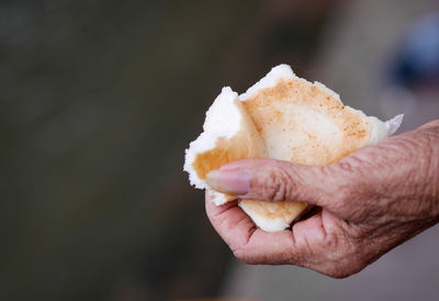 Close-up of hand holding ice cream