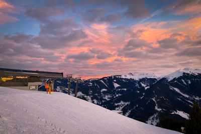 Arrival of schönleiten cable car ski lift in saalbach-hinterglemm against burning sky at sunset