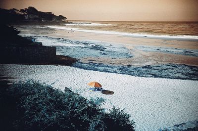 Scenic view of sea at beach during sunset