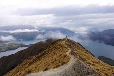 Scenic view of mountains against cloudy sky