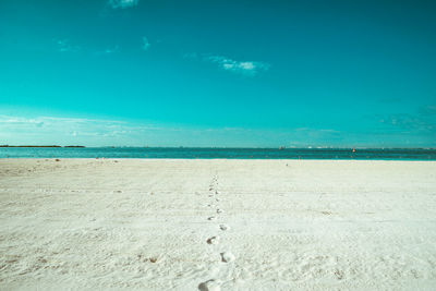 Scenic view of beach against blue sky