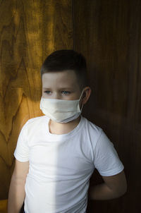 Close-up of boy against wall