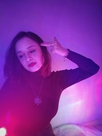 Portrait of young woman against blue sky