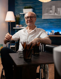 Midsection of man sitting at table