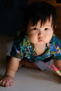 Close-up of cute girl looking away at home