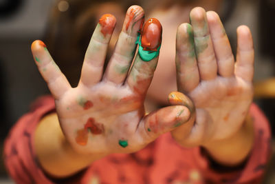 Close-up of boy showing painted hands