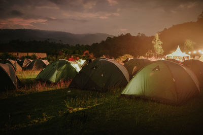 Tent on field against sky during sunset