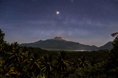 Scenic view of mountains against sky at night