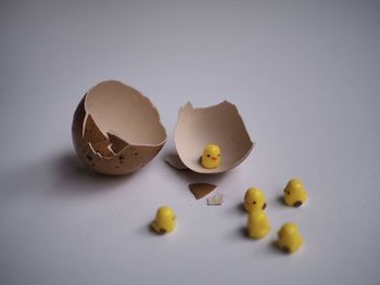 Close-up of broken egg over white background