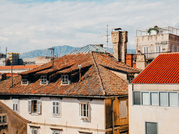 Residential buildings in city against sky