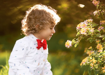 Boy standing on flowering plant