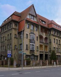 Old building by street against sky