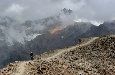 Full length of man standing on landscape against mountain range