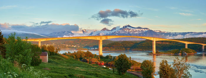 Bridge over mountains against sky