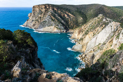 High angle view of rocks on sea shore