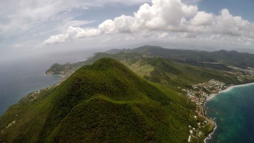 Scenic view of sea and mountains against sky