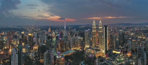 High angle view of illuminated buildings against sky during sunset