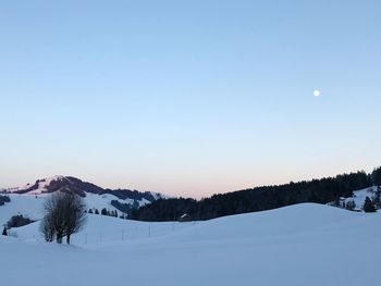 Scenic view of snowcapped mountains against clear sky