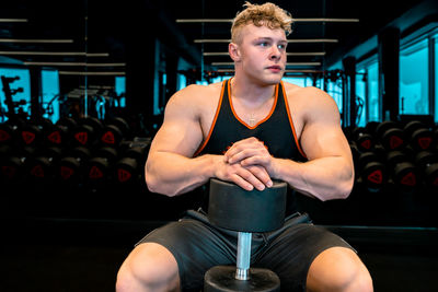 Portrait of young woman exercising in gym