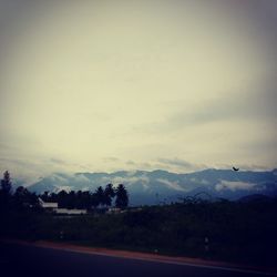 Scenic view of mountains against cloudy sky