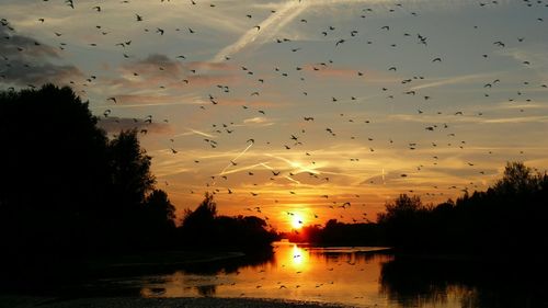 Scenic view of lake against sky during sunset