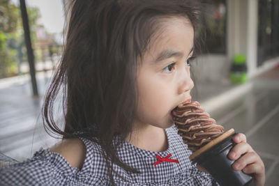 Portrait of cute girl looking away while ice cream