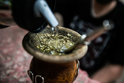 Close-up of hand pouring tea