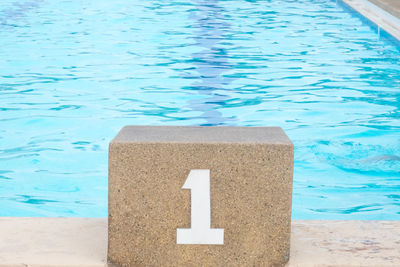 High angle view of warning sign on swimming pool