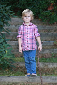 Portrait of girl standing against tree