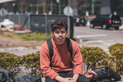 Portrait of young man sitting outdoors