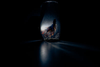 Close-up of blue glass over black background