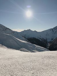 Scenic view of snowcapped mountains against sky