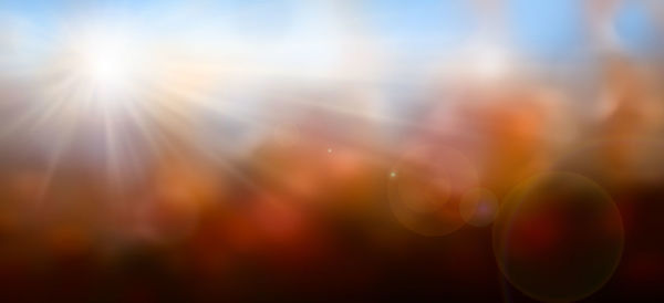 Defocused image of bubbles against sky during sunset