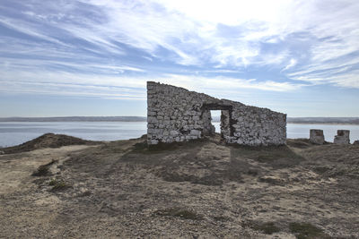 Built structure on beach against sky