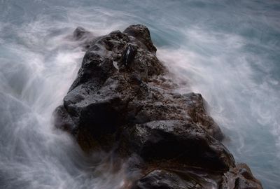 Scenic view of waves on rocks