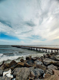 Bridge over sea against sky