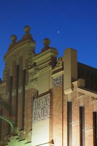 Low angle view of ornate building against blue sky