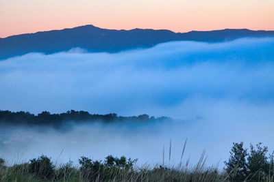 Scenic view of mountains against sky during sunset